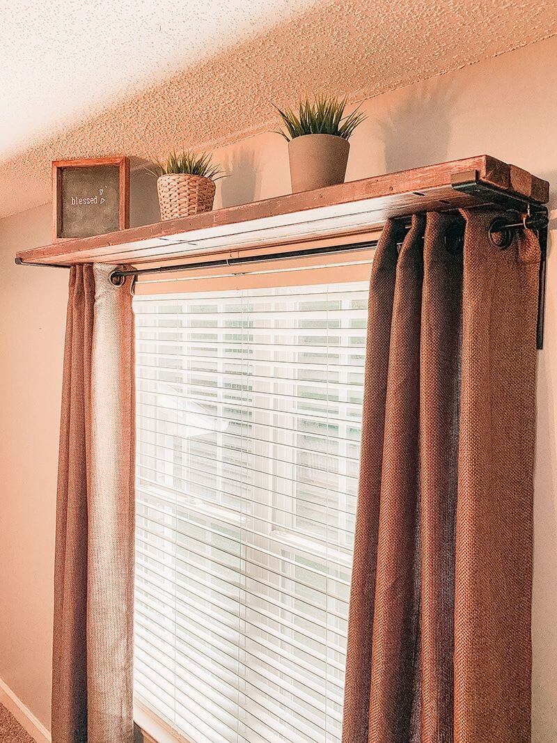 Wooden Shelf Above Curtains Holds Small Decor