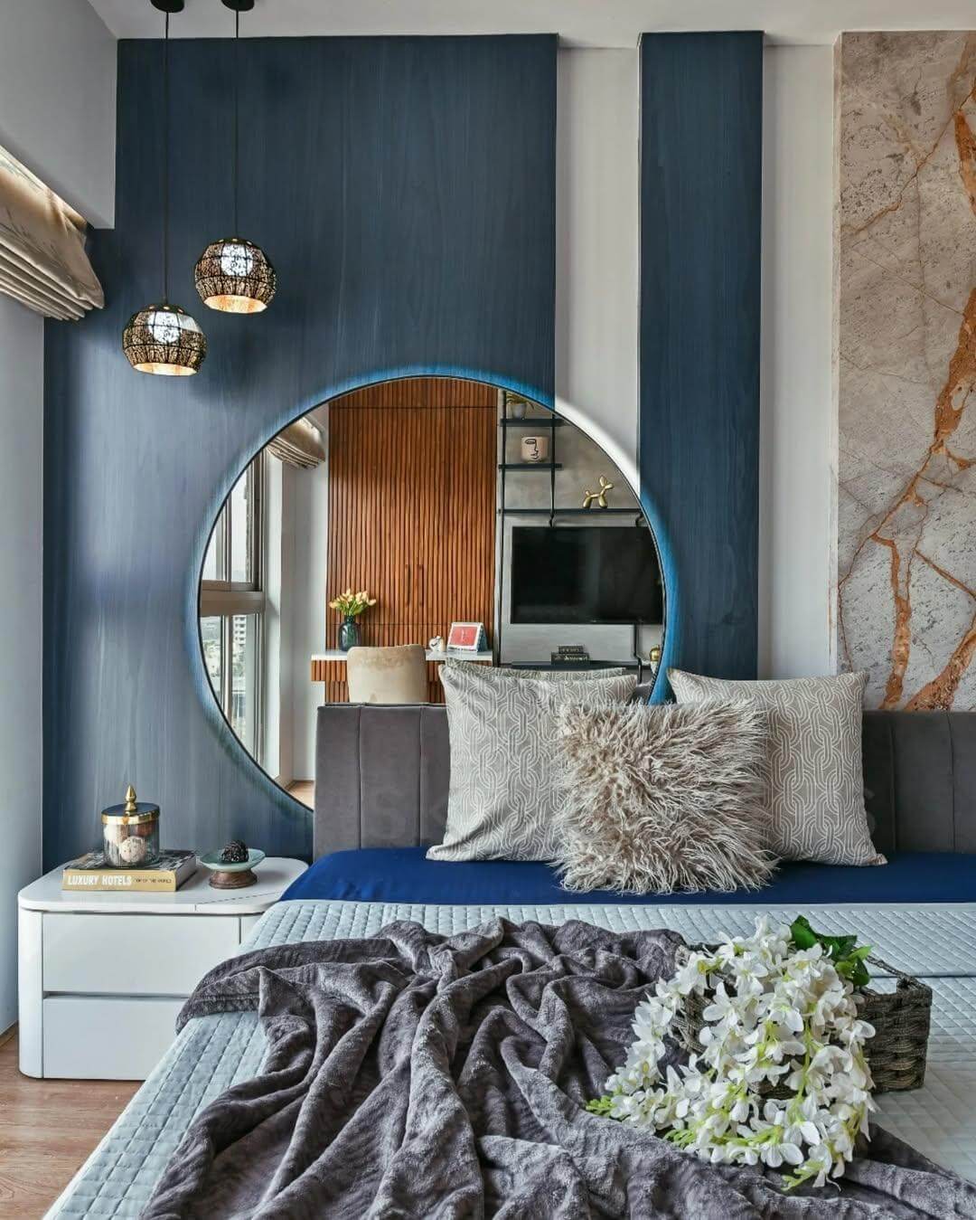 Circular Mirror with Integrated Lighting Frames a Textured Wall