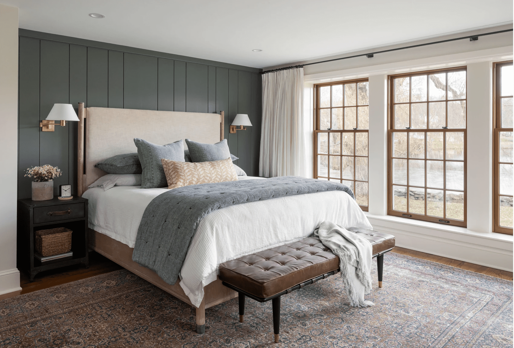 Dark Shiplap Walls Add Moody Depth Behind the Bed
