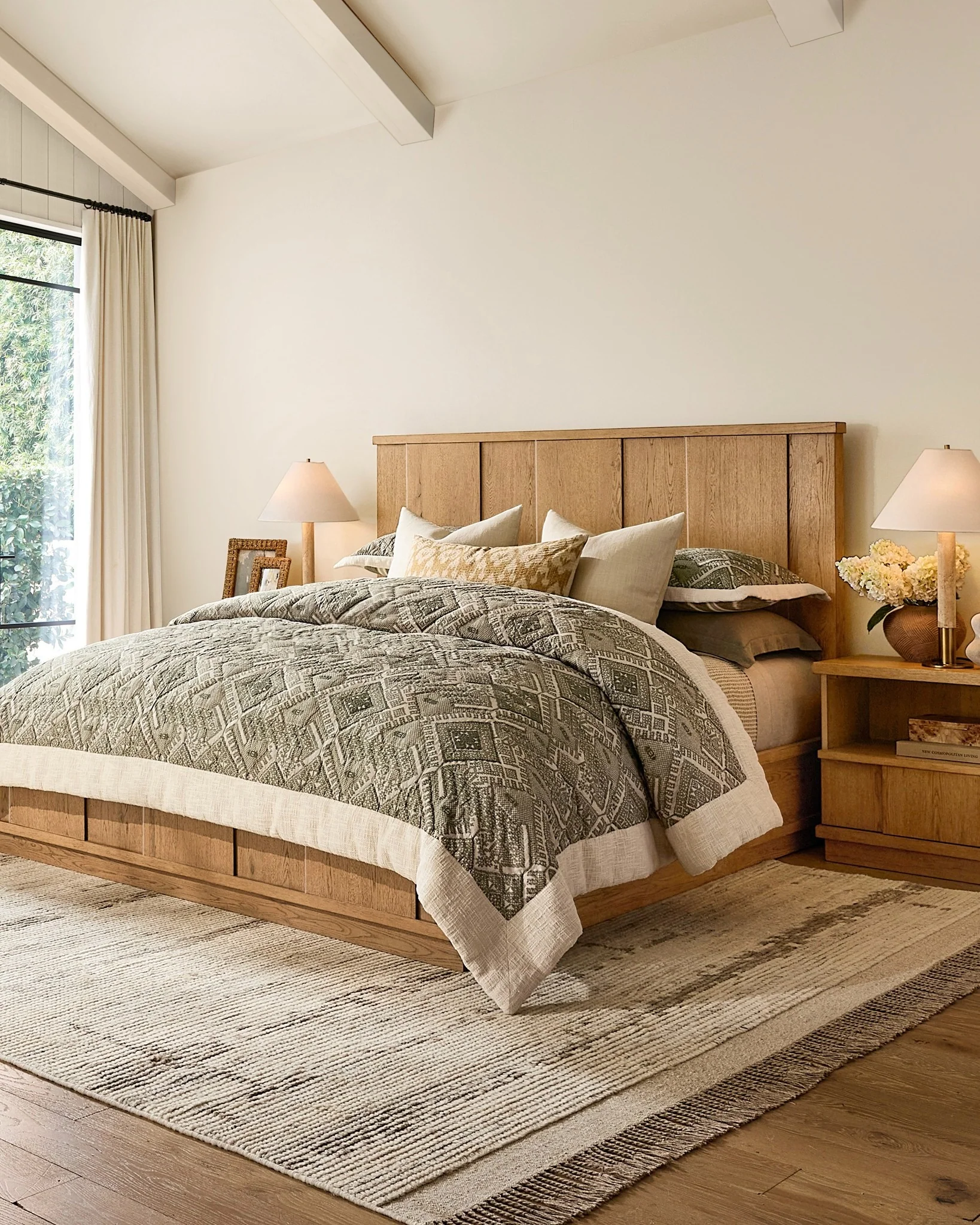 Striped Rug Adds Subtle Pattern to Wood-Toned Bedroom