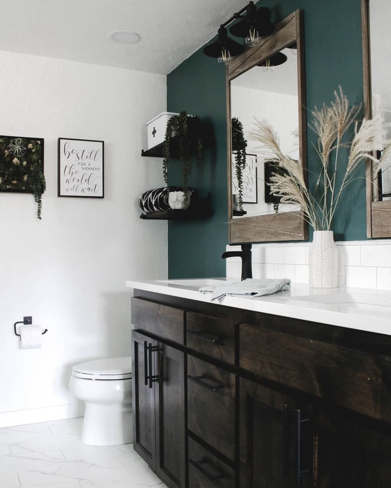 Deep Teal Accent Wall Frames a Rustic Wood Mirror