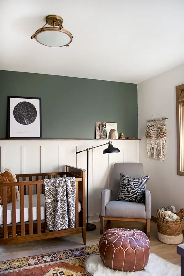 Deep Green Accent Wall Highlights Celestial Art and Books