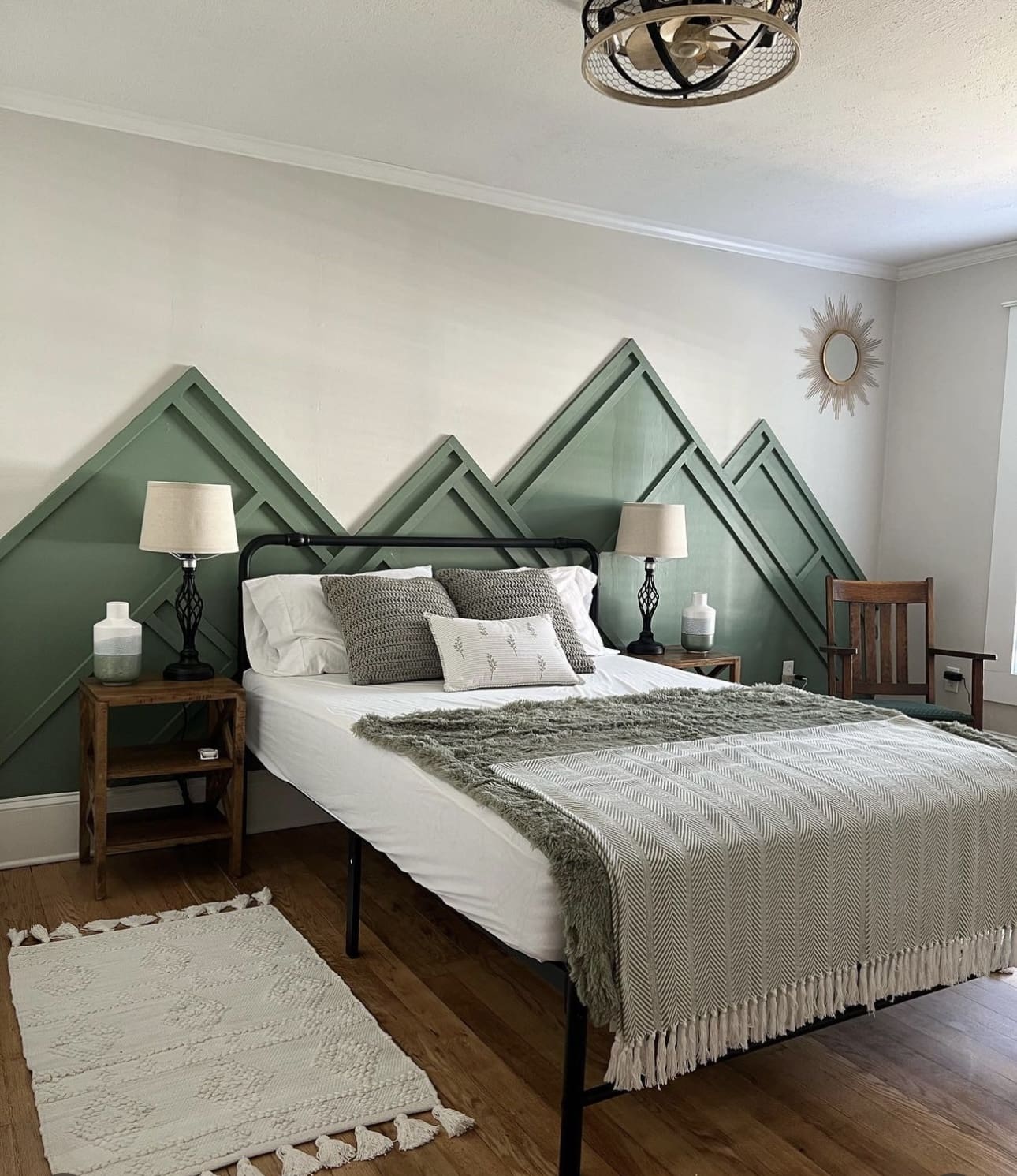 Geometric Green Trim Mimics Mountain Peaks Above Bed