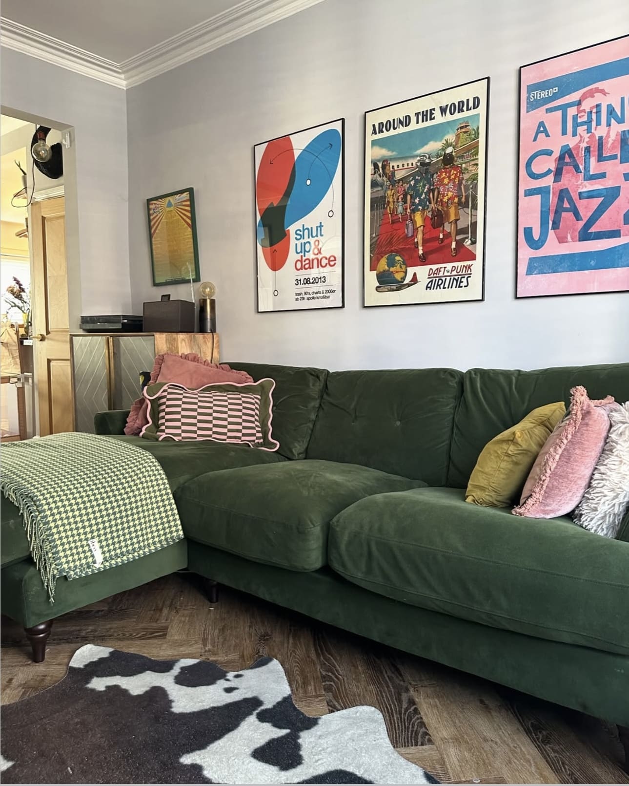 Gallery Wall of Retro Posters Adds Personality Above the Sofa