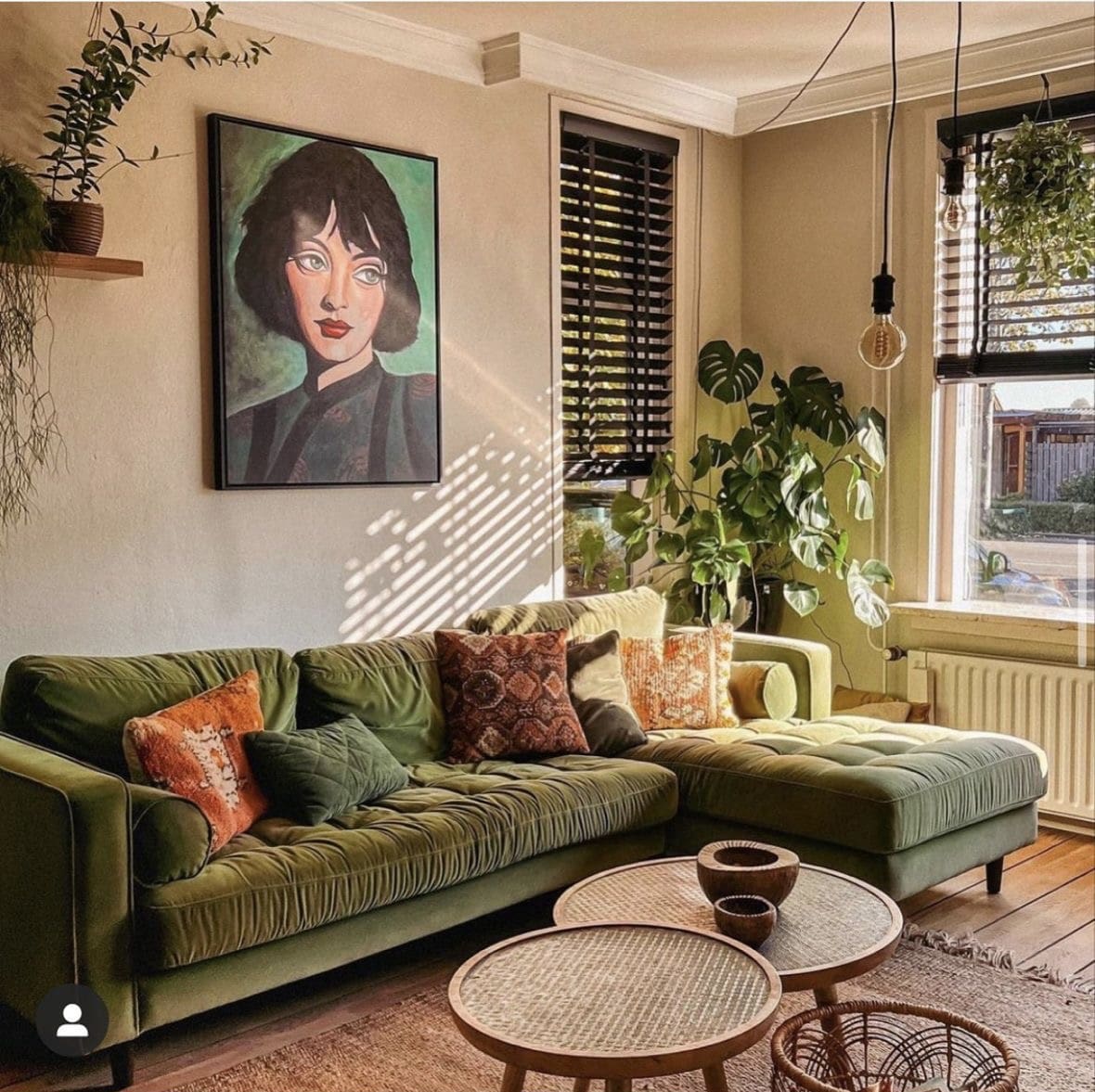 Bold Portrait Art Anchors the Green Sofa Arrangement