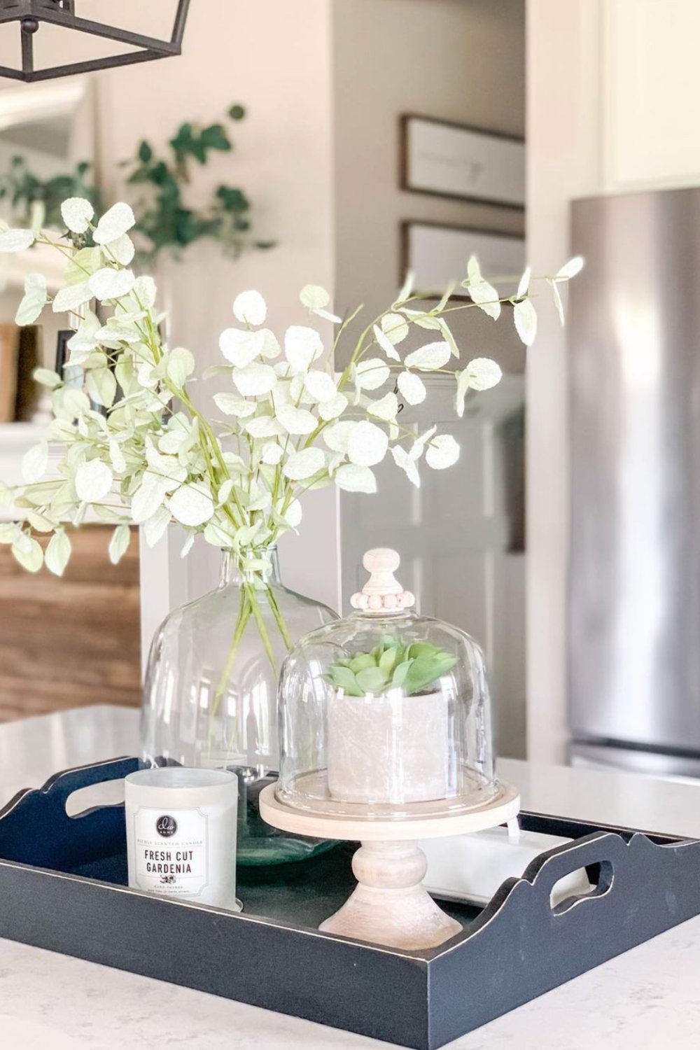 Glass Cloche Displays a Small Potted Plant on a Pedestal