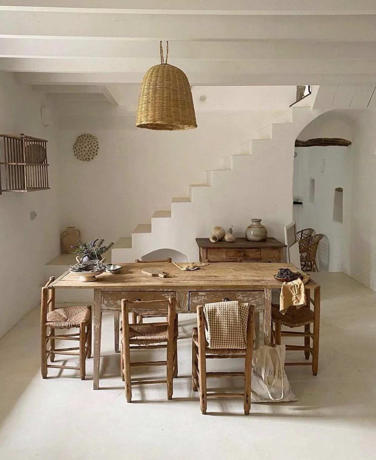 Woven Bell Pendant Adds Natural Texture Above the Dining Area