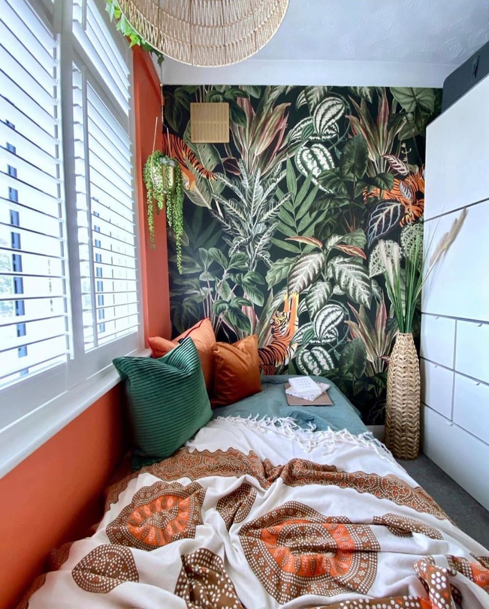 Orange and Green Pillows Accent a Tropical Bedroom