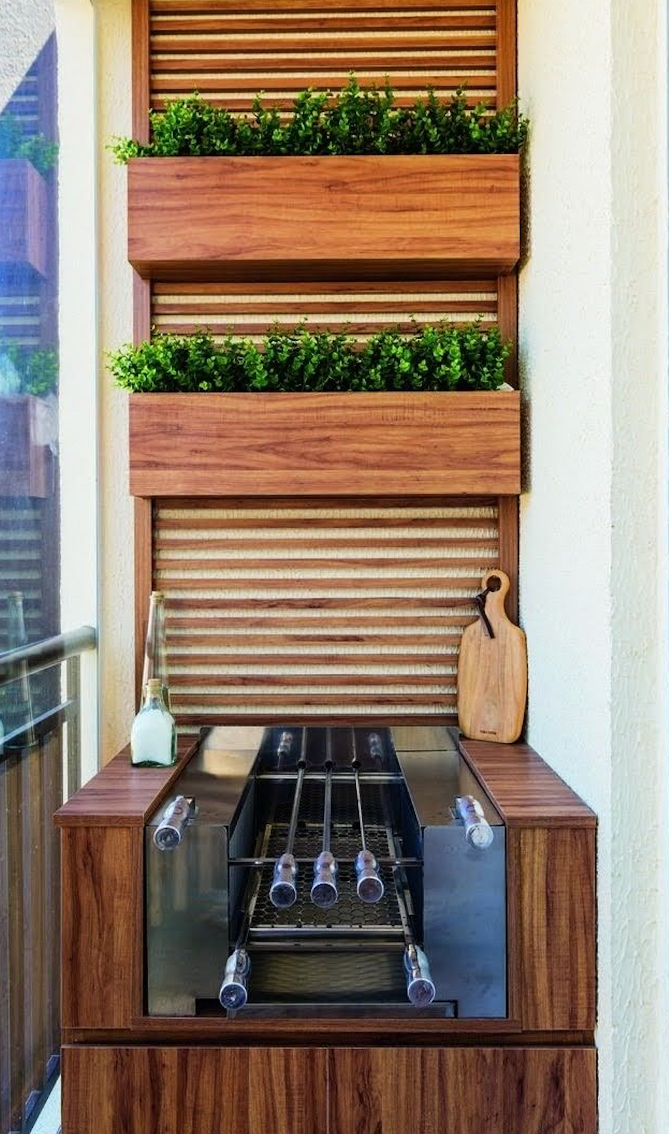 Stacked wooden planters add vertical greenery to your grill area