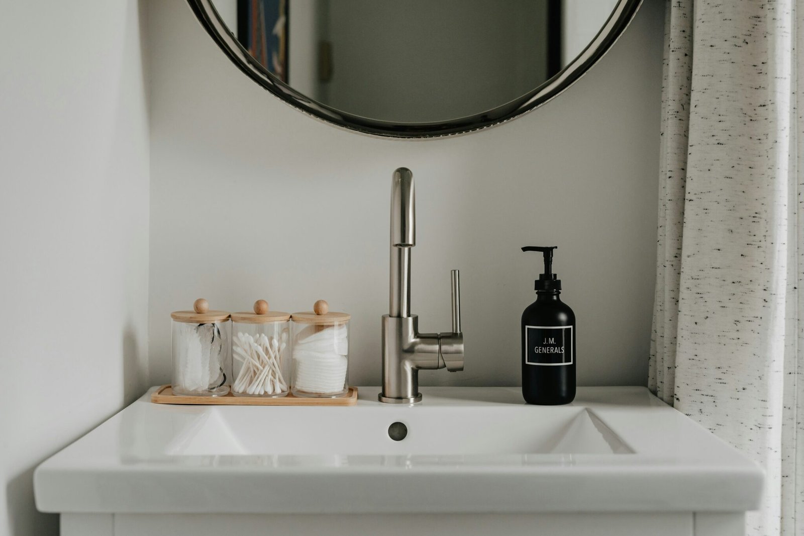 Glass Canisters With Wood Lids Organize Cotton Swabs and Rounds