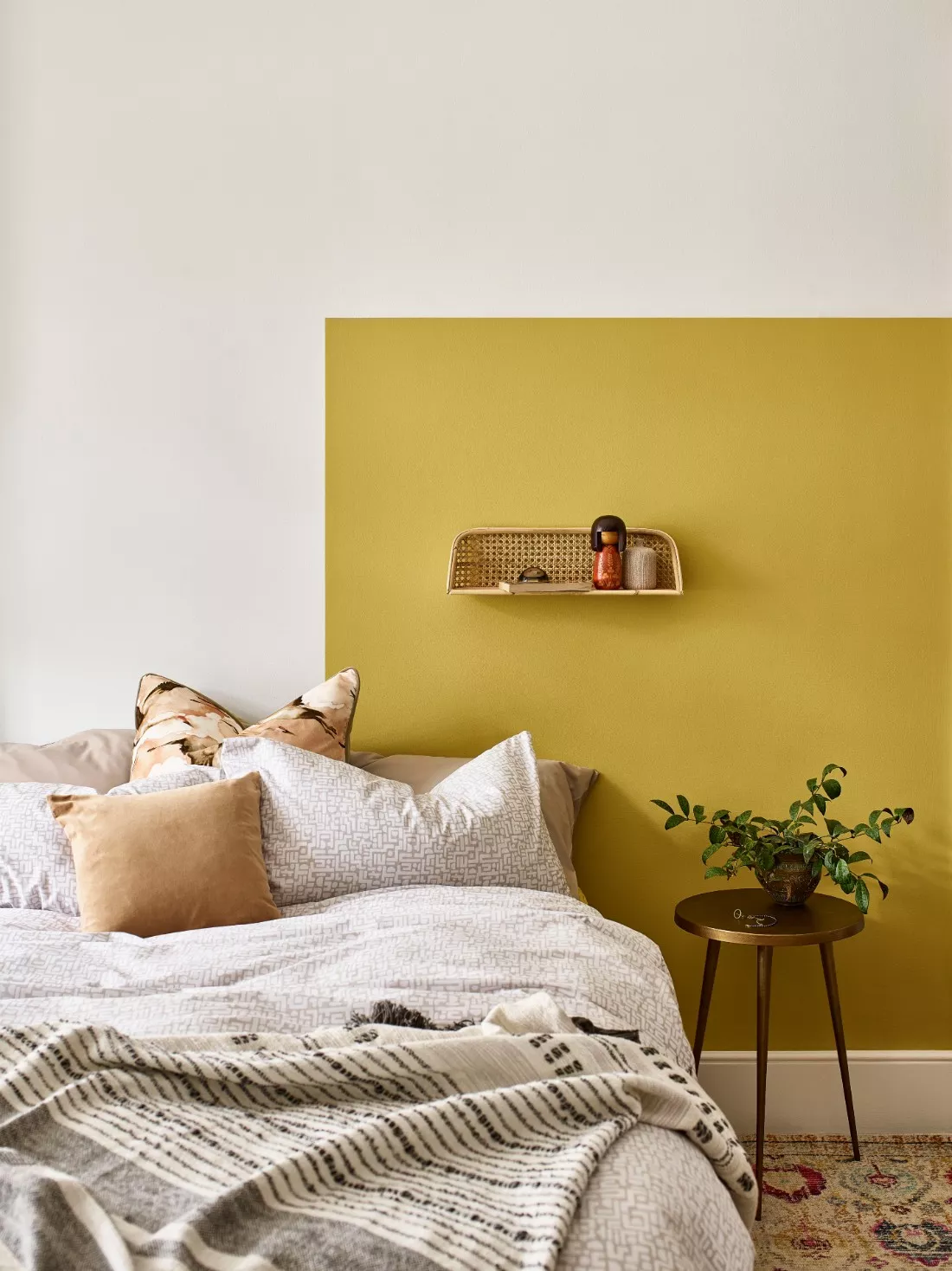 Yellow Accent Wall Creates a Sunny Backdrop Behind the Bed