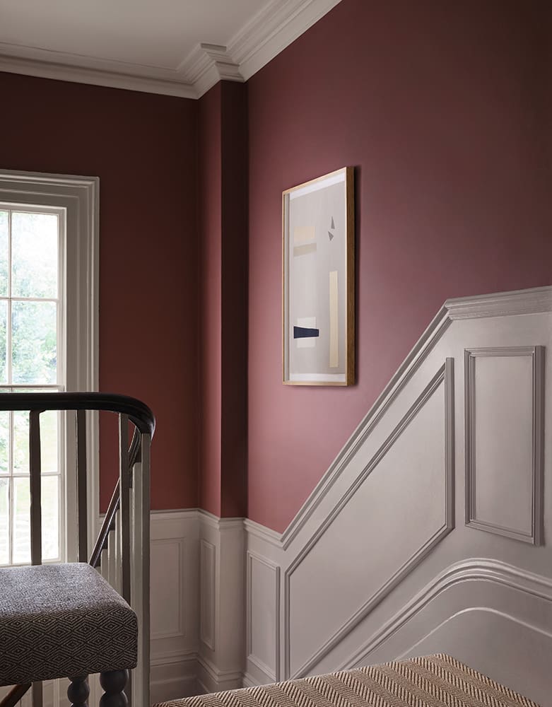 Introduce Richness with Deep Rose Walls and White Wainscoting