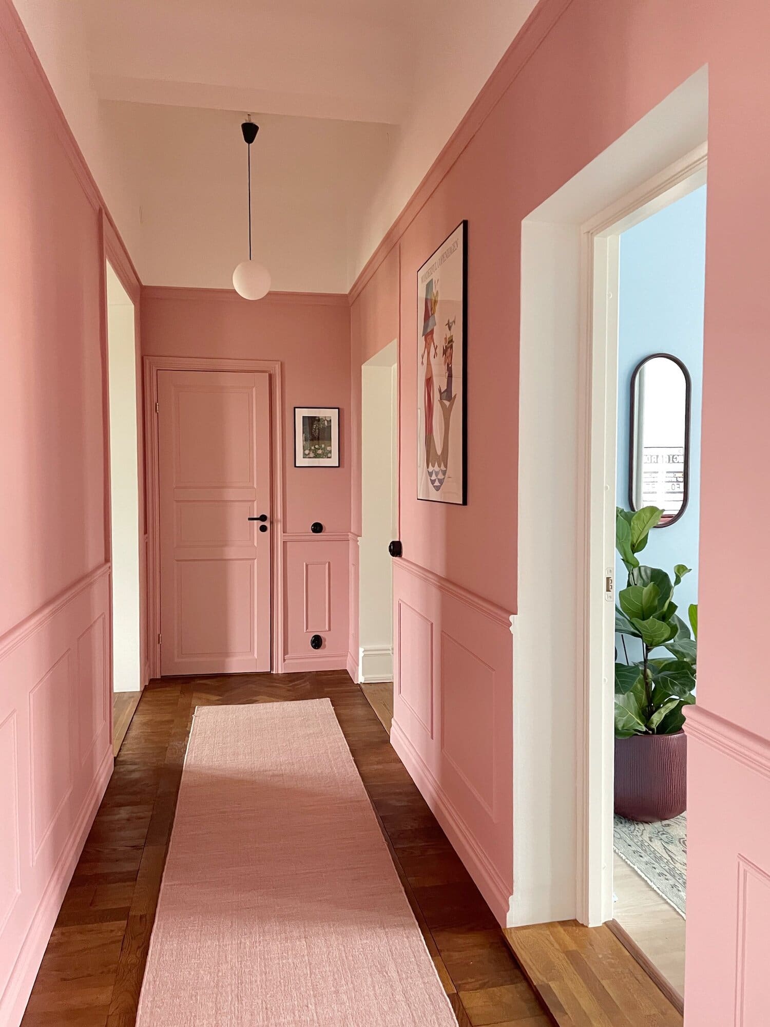 Soften Your Hallway with Pink Paneled Walls and Contrasting Art