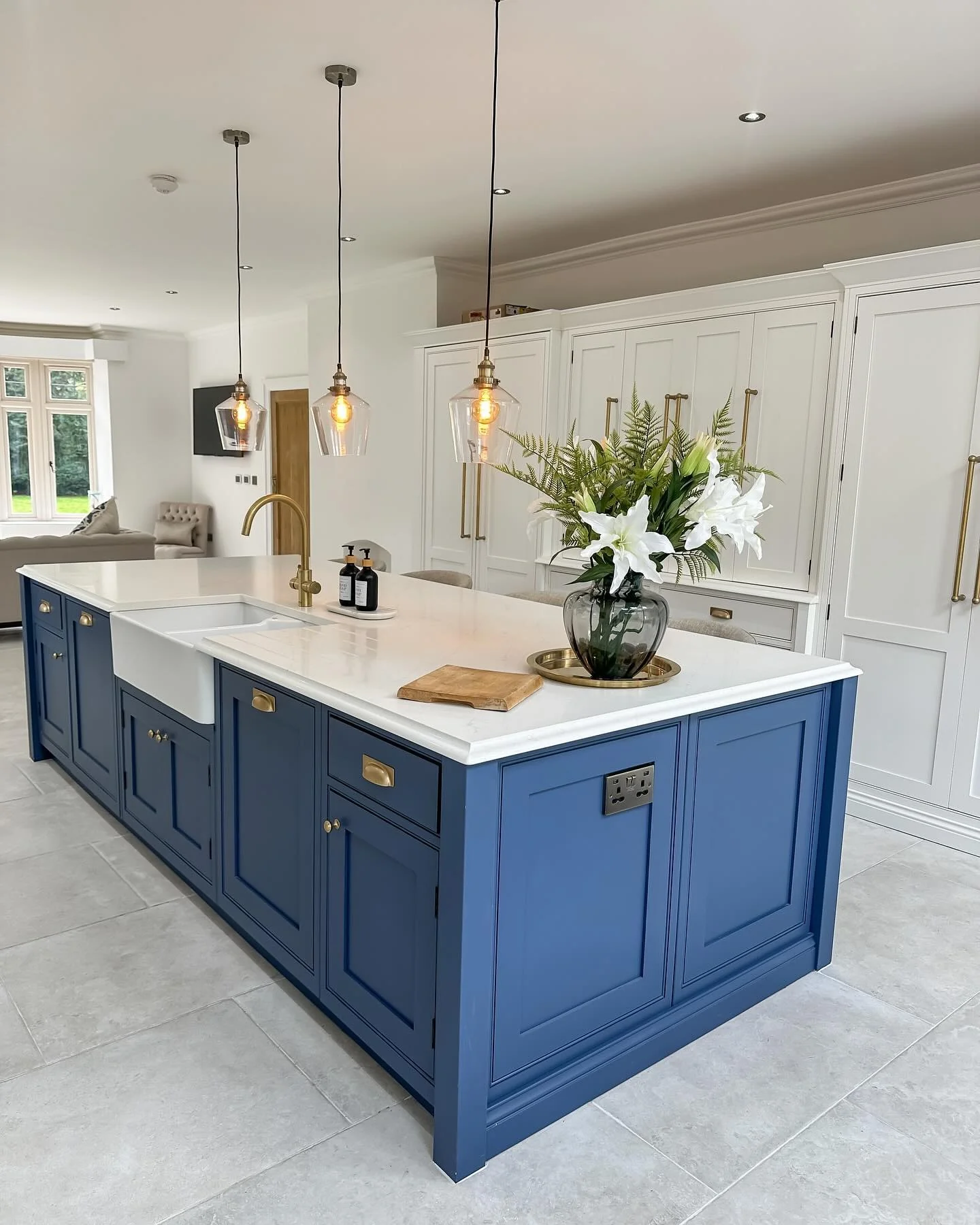 Glass Pendant Lights Cast a Warm Glow Above White Counters
