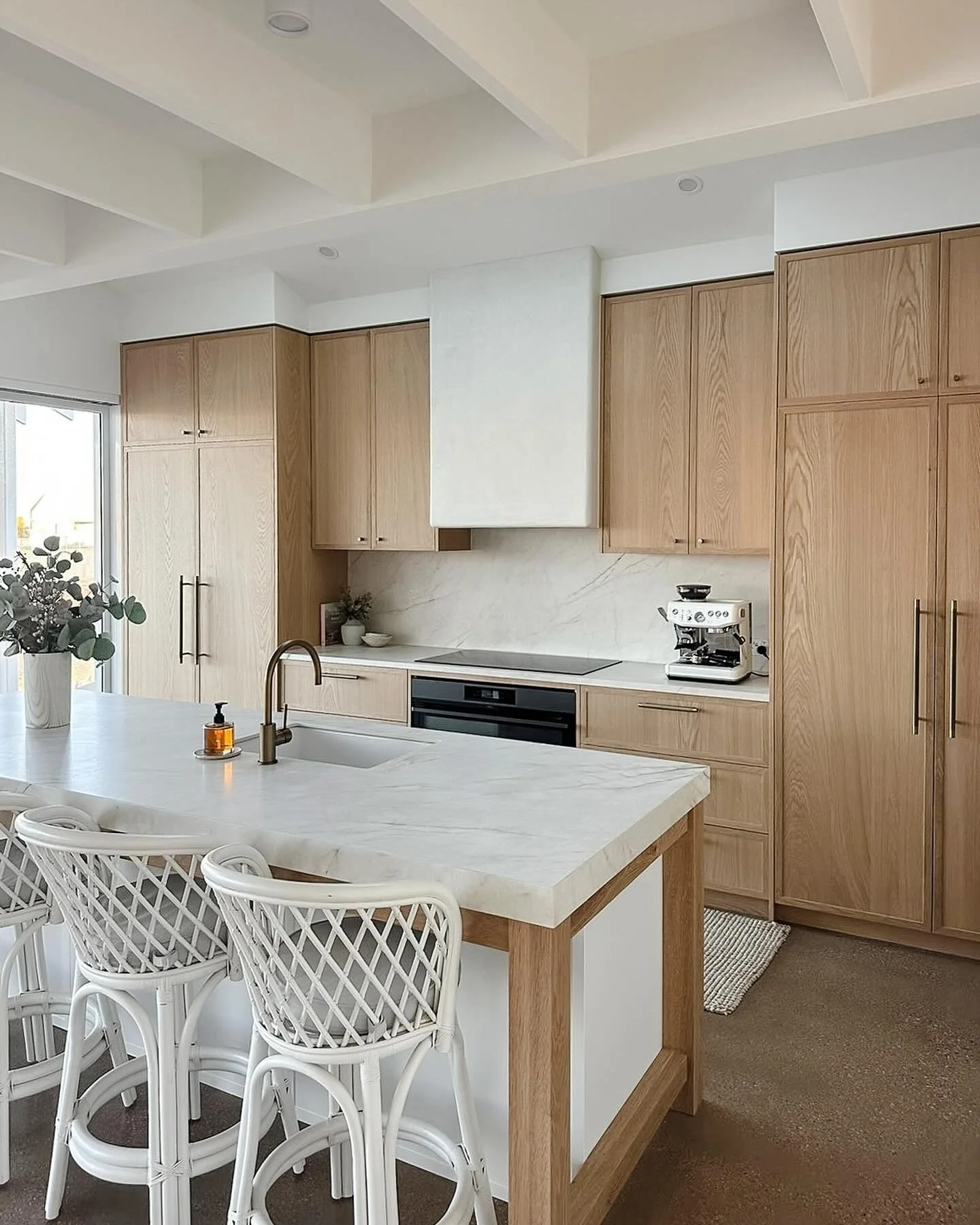 Warm Wood Cabinets Pair Beautifully with White Marble