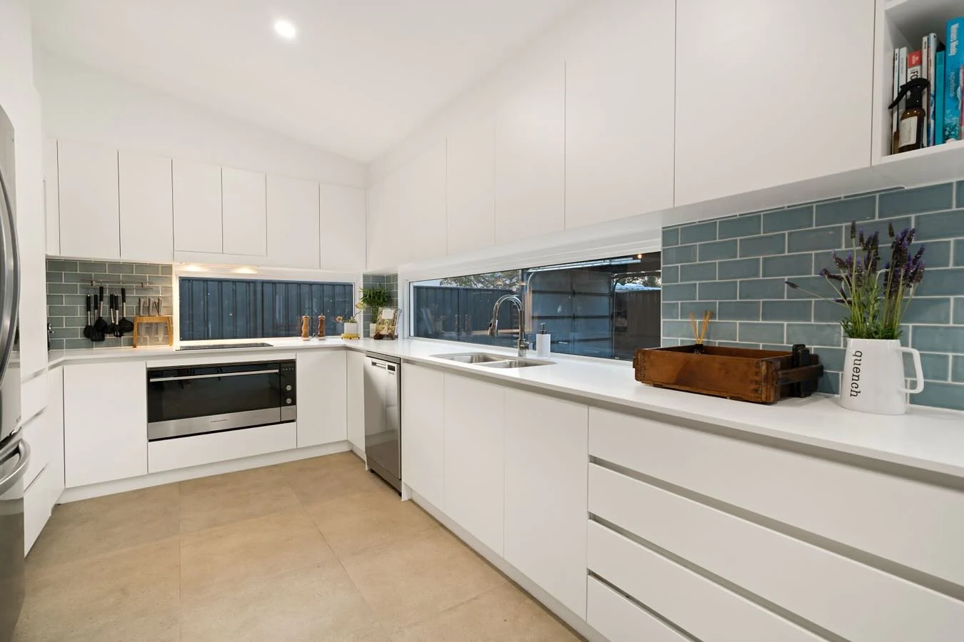 Blue Subway Tile Backsplash Adds Subtle Color to White Kitchen