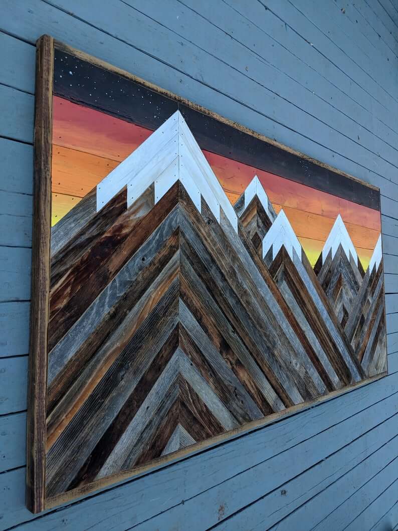 Layered Wood Art Captures a Mountain Sunset Scene