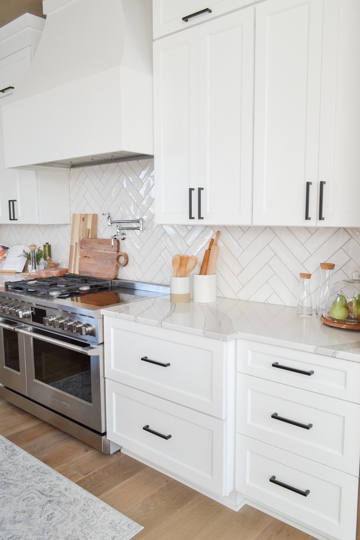 White Herringbone Tile Backsplash Adds Subtle Movement