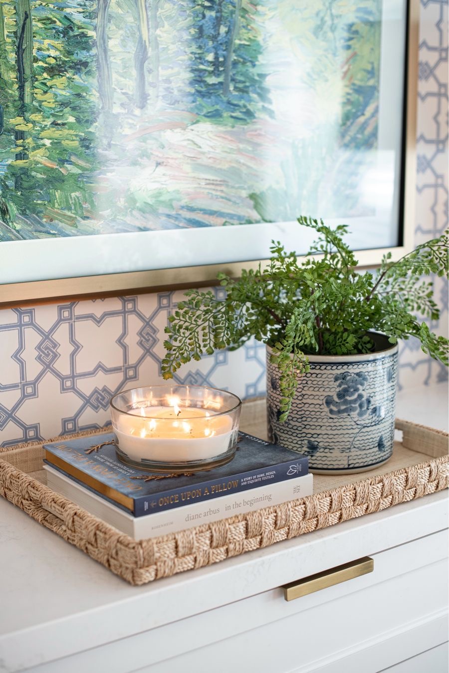 Blue and white patterned planter holds a leafy green fern