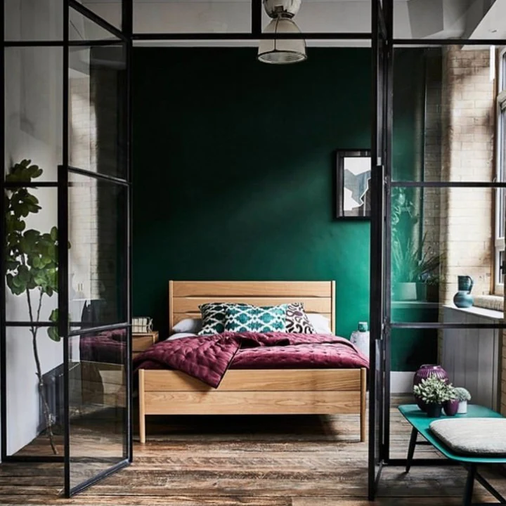 Deep Green Walls Create a Moody Backdrop for Wood Furniture