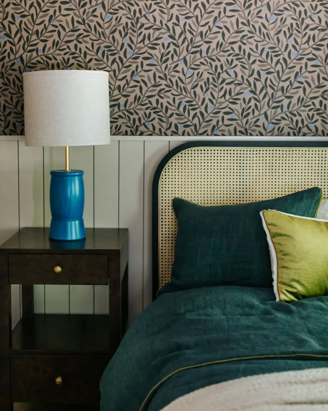 Rattan Headboard Adds Natural Texture to Deep Green Bedding