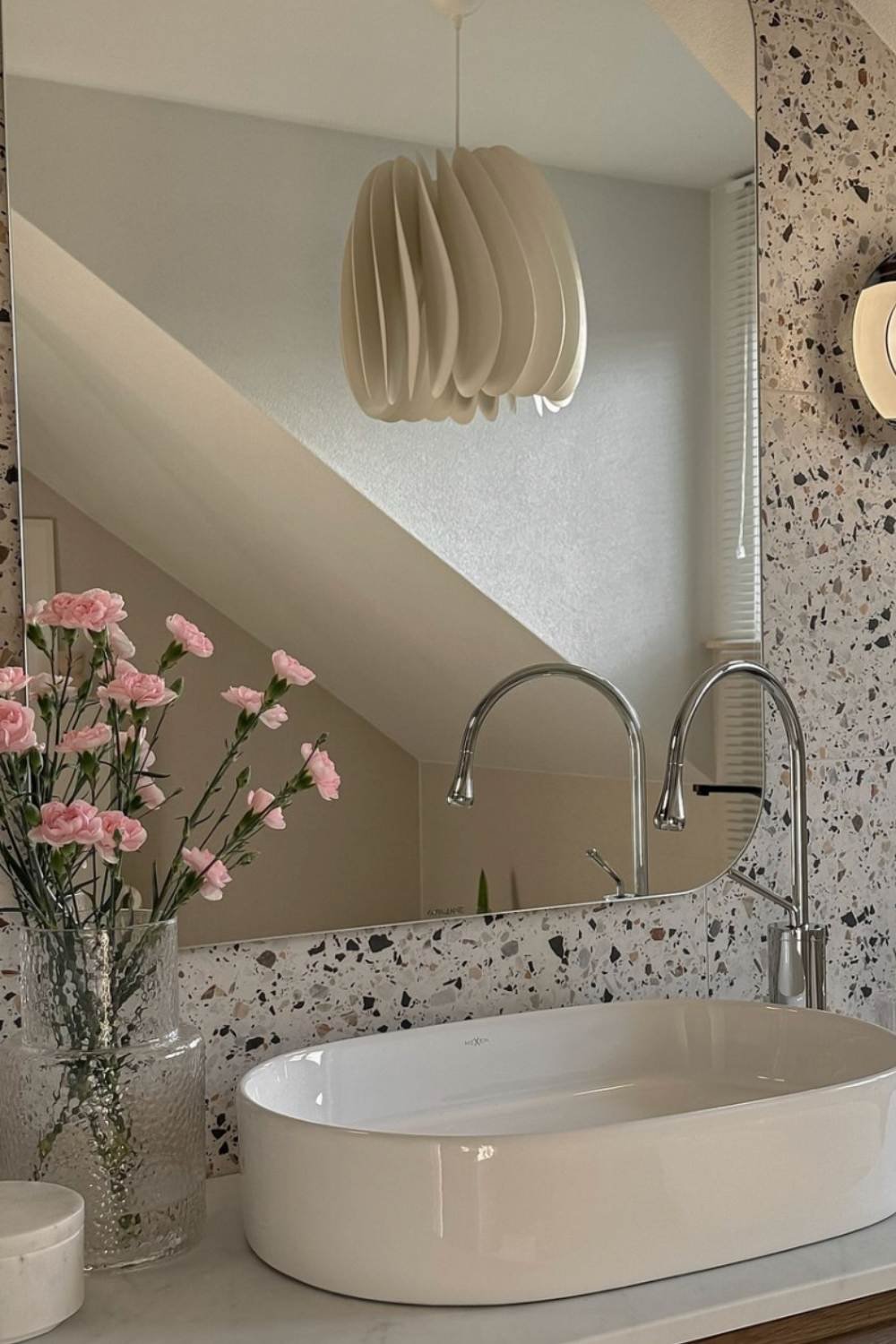 Curved Mirror and Terrazzo Tile Create a Modern Vanity