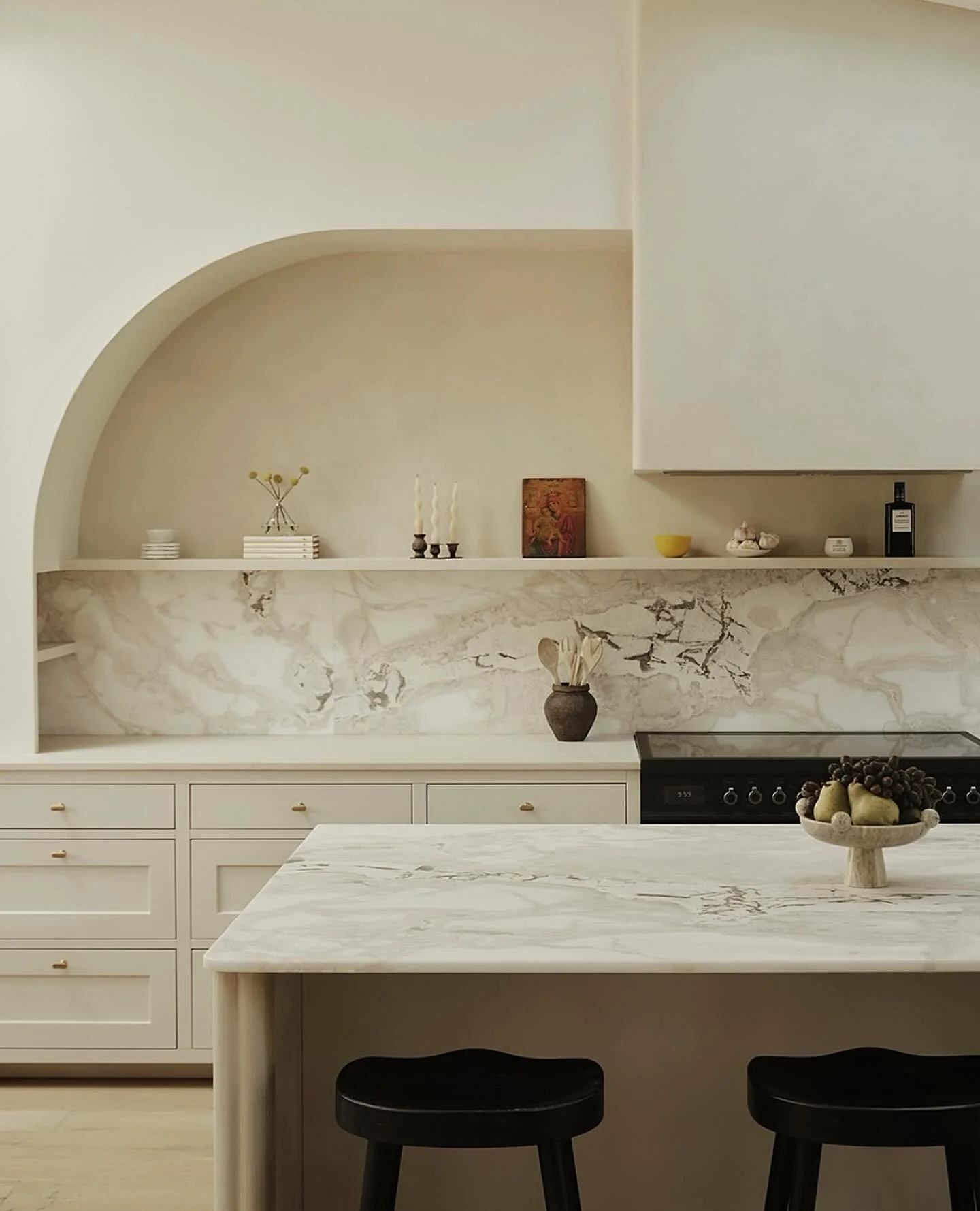 Arched Niche Creates a Soft Architectural Moment Above Shelving