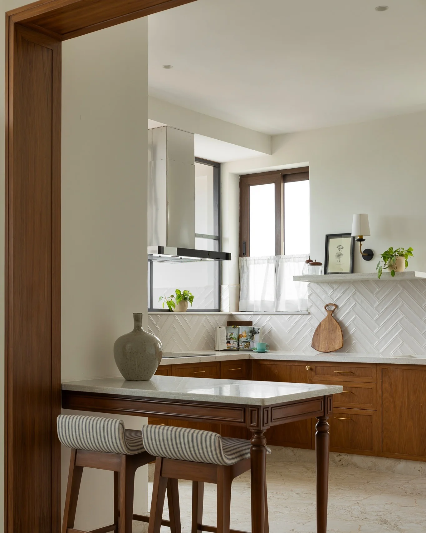 Herringbone Tile Adds Subtle Dimension to Wood Cabinets