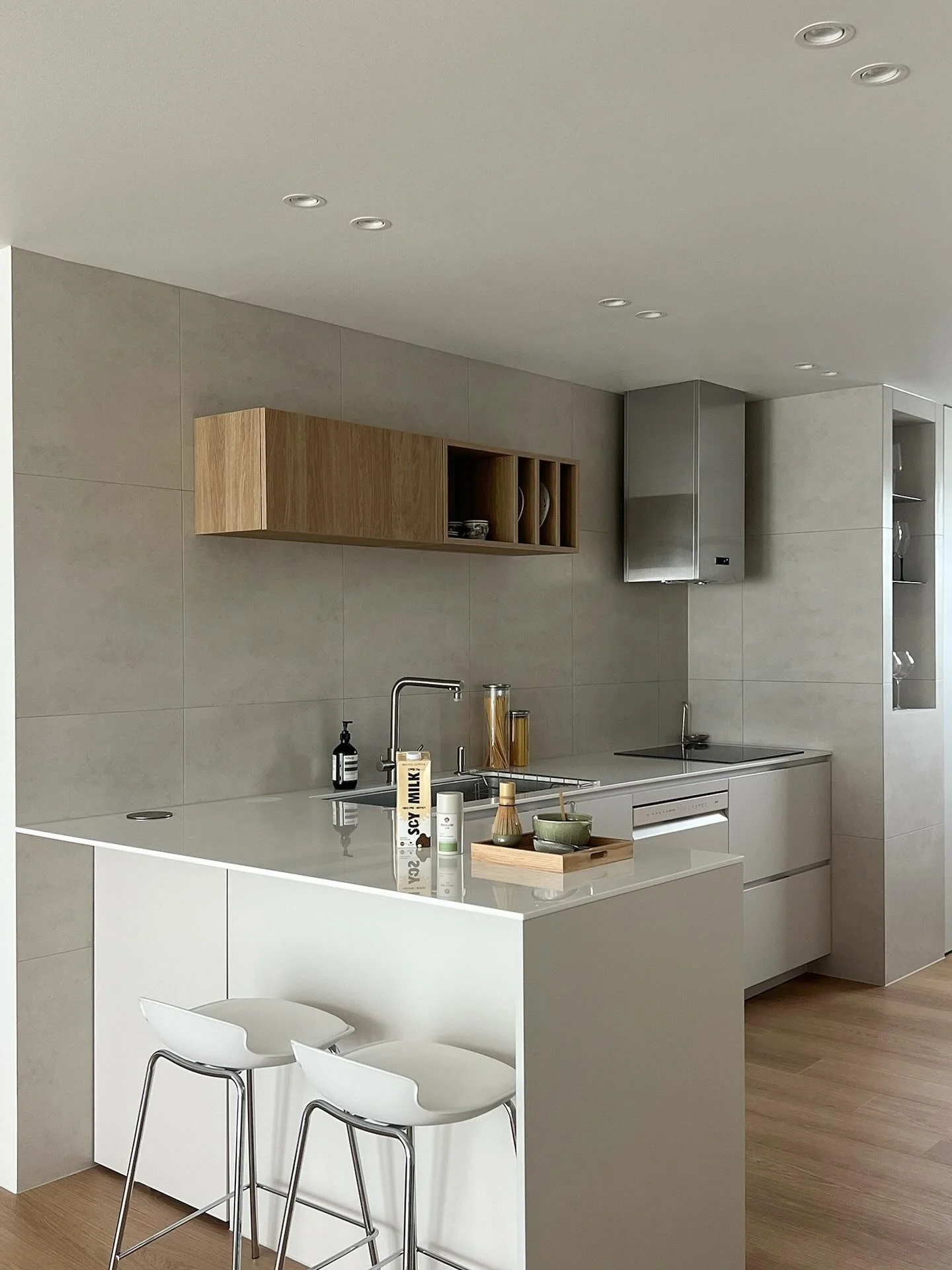 Floating Wood Cabinet Adds Warmth Above Tiled Walls