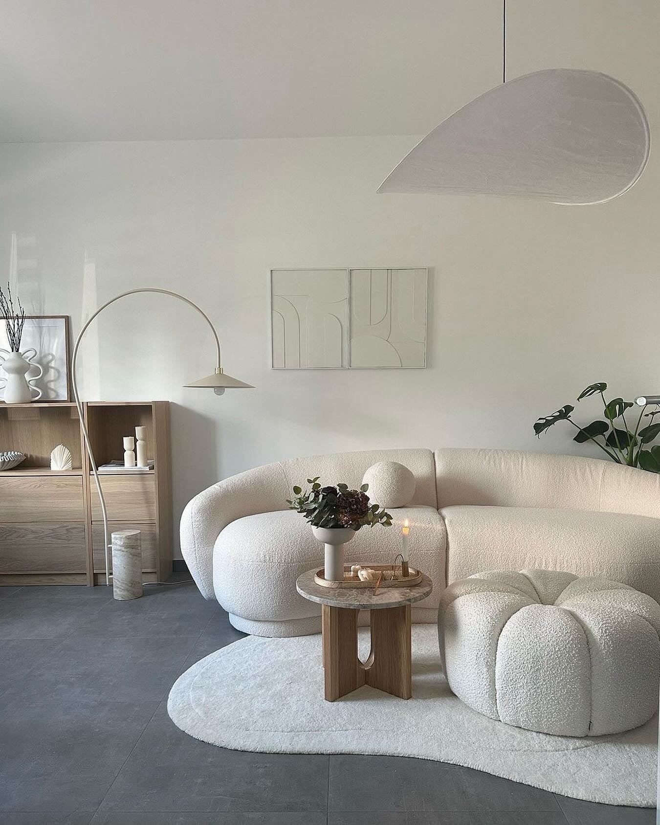 Curved Bouclรฉ Sofa With Round Pillow Accent