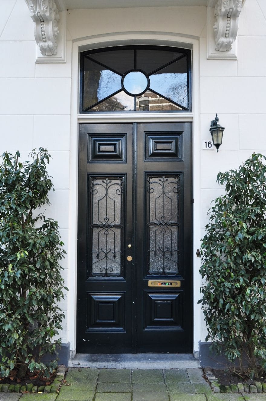 Ornate Scrollwork Adds Delicate Detail to Black Door Panes