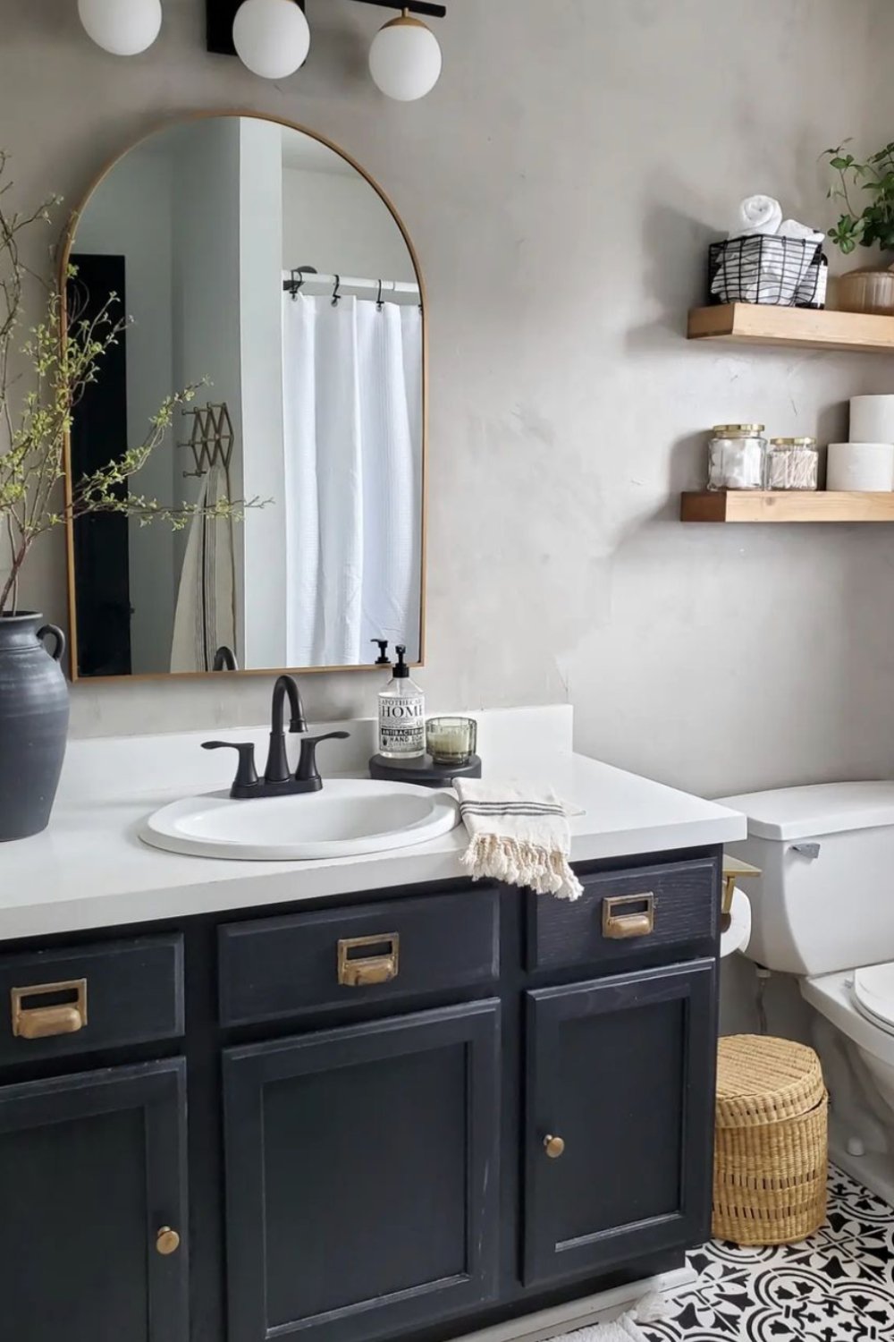 Choose a dark vanity with brass drawer pulls for vintage flair