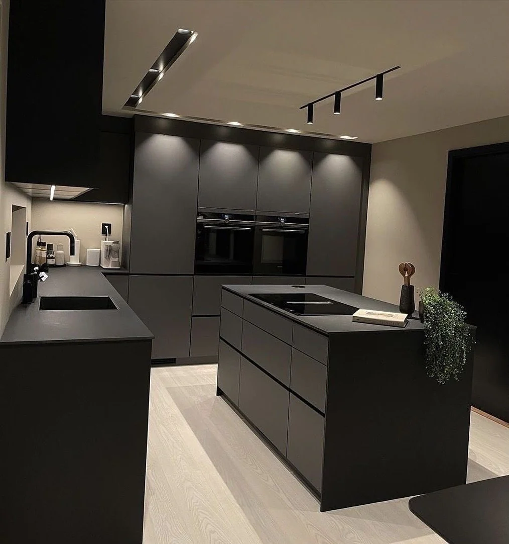 Matte Black Island With Integrated Cooktop Creates a Sleek Hub