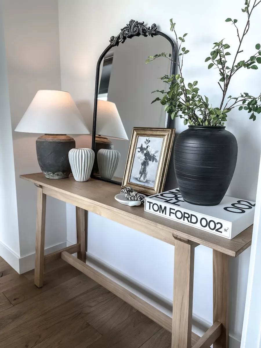 Tall Black Vase Anchors Entryway Table With Branches