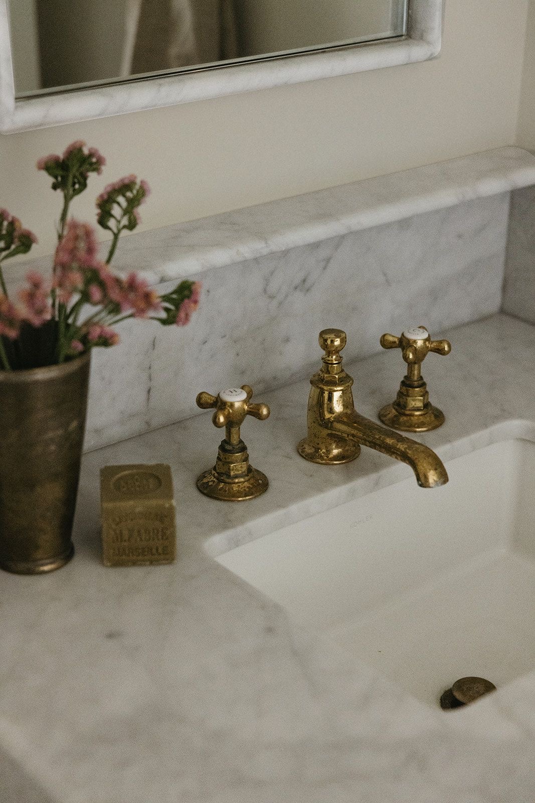 Antique Brass Faucet Adds Timeless Warmth to Marble Countertop