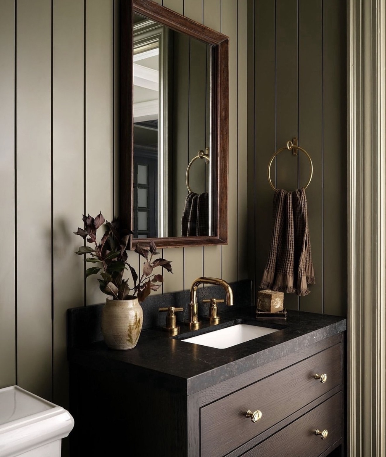 Dark Wood Vanity With Brass Knobs Adds Richness