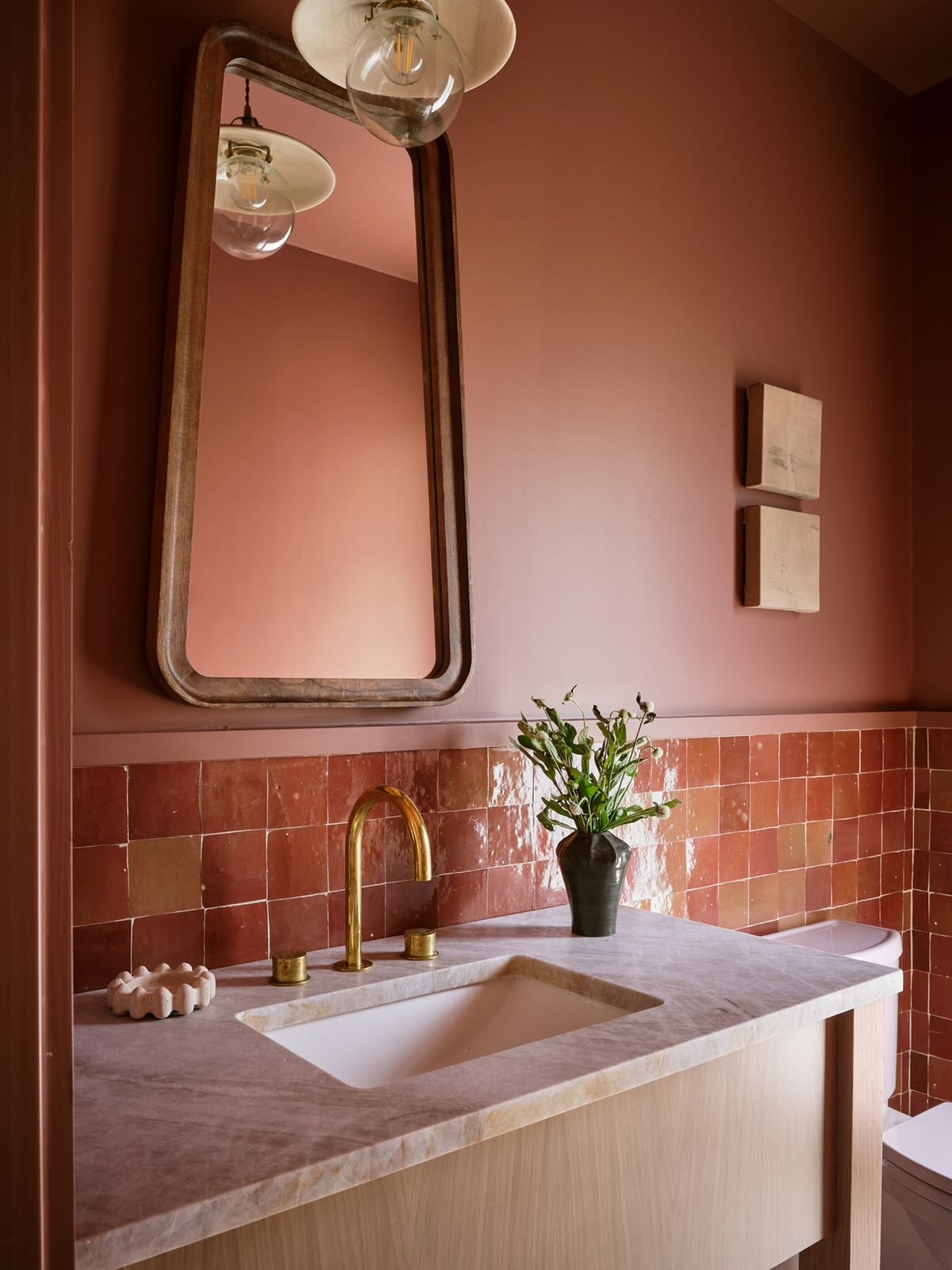 Terracotta Tile Backsplash Adds Warmth to Marble Vanity