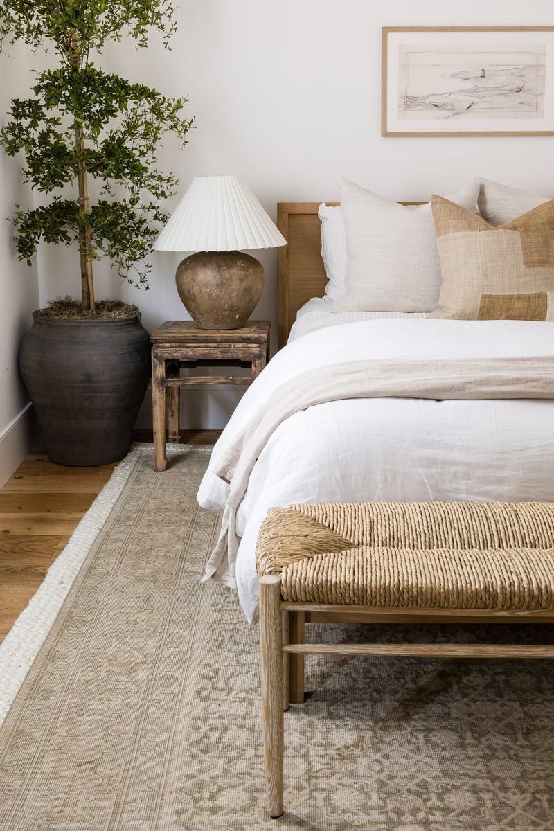 Large Dark Planter Grounds Bedroom With Lush Greenery