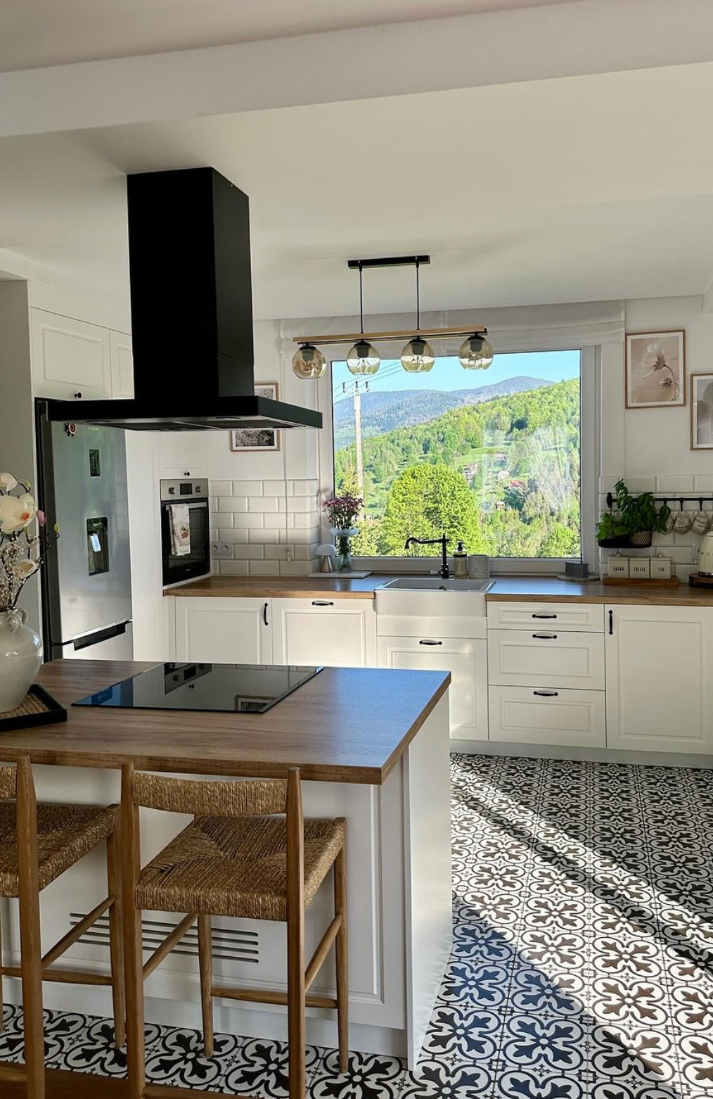 Bold Geometric Floor Tiles Ground the Kitchen's White Cabinets