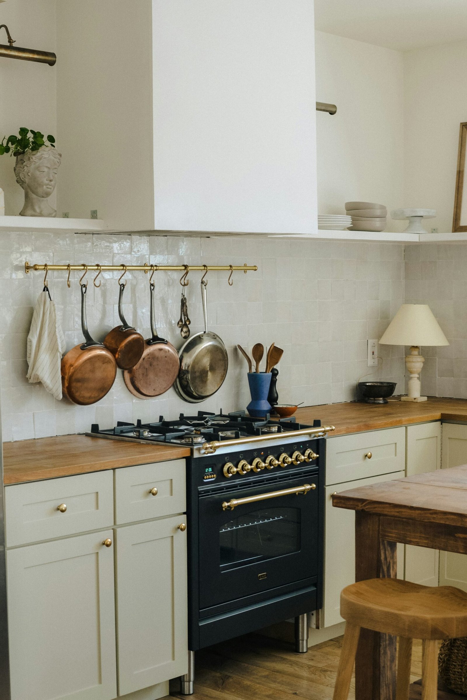 Brass Pot Rack Adds Warmth to White Tile Backsplash