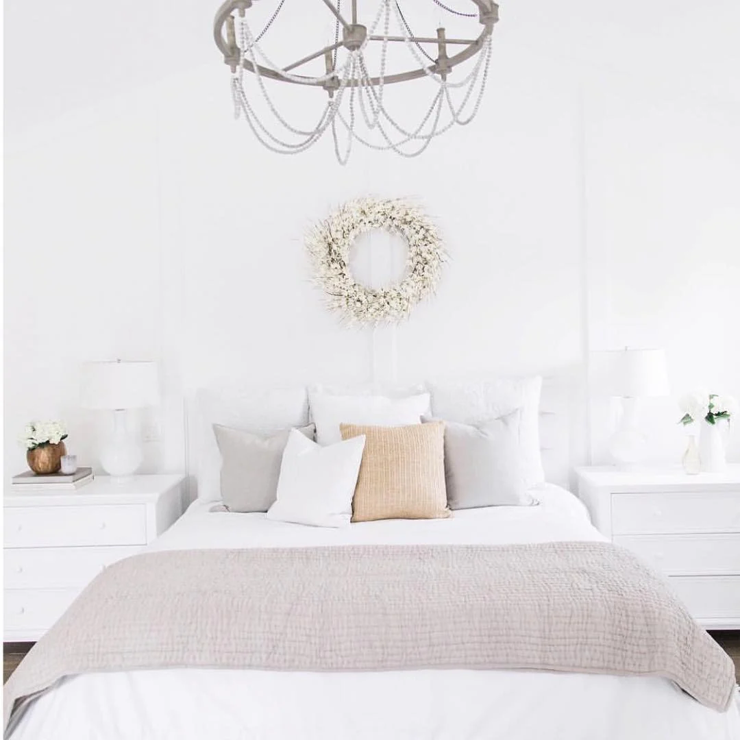 White Dried Flower Wreath Adds Organic Texture Above the Bed