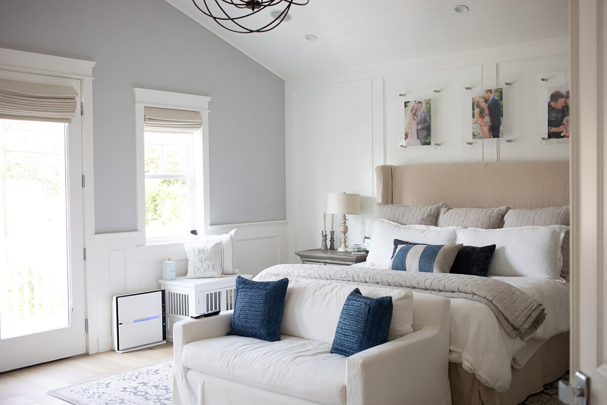 Floating Acrylic Frames Display Personal Photos Above the Bed