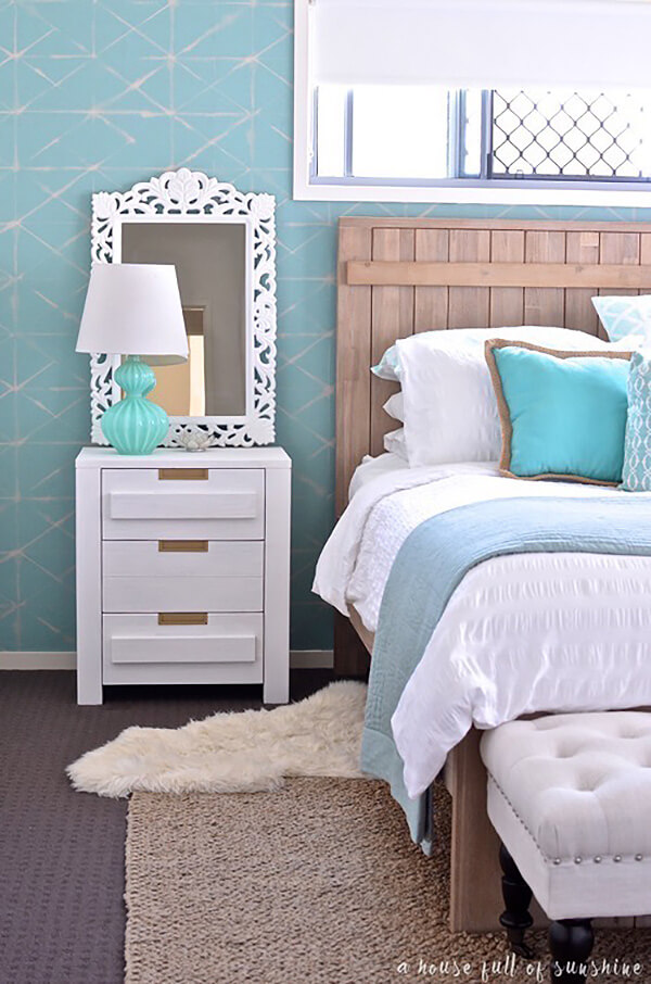 Ornate White Mirror Frames a Coastal Nightstand