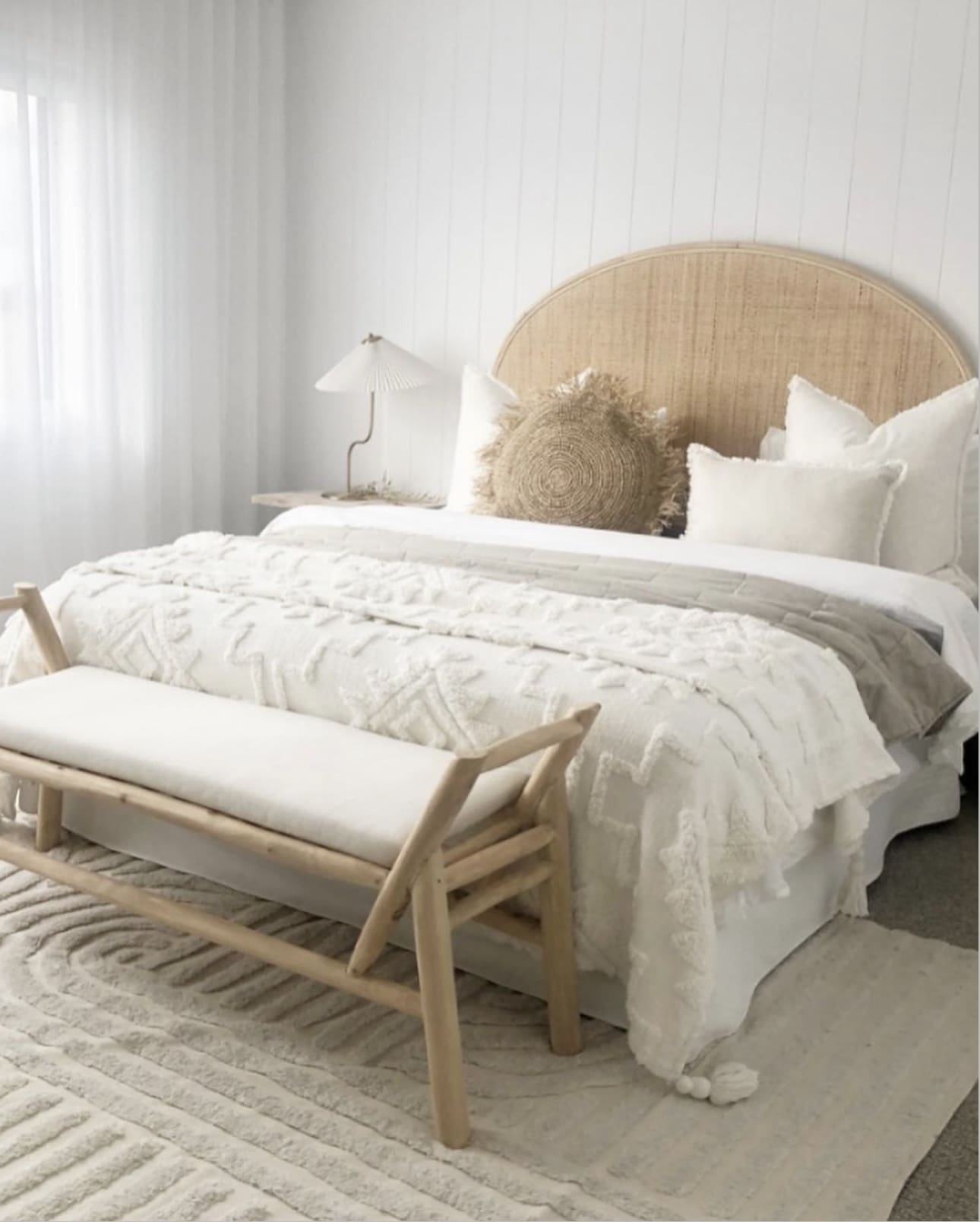 Rattan Headboard Frames a Serene Coastal Bedroom