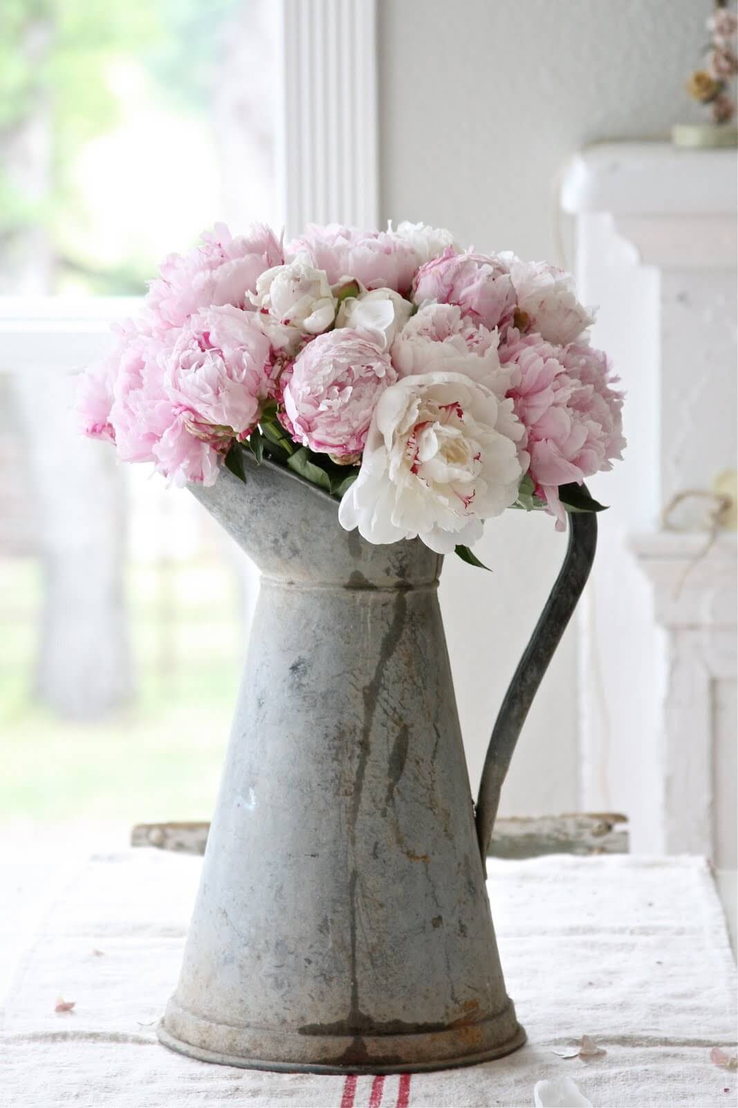 Galvanized Pitcher Holds A Lush Bouquet Of Peonies