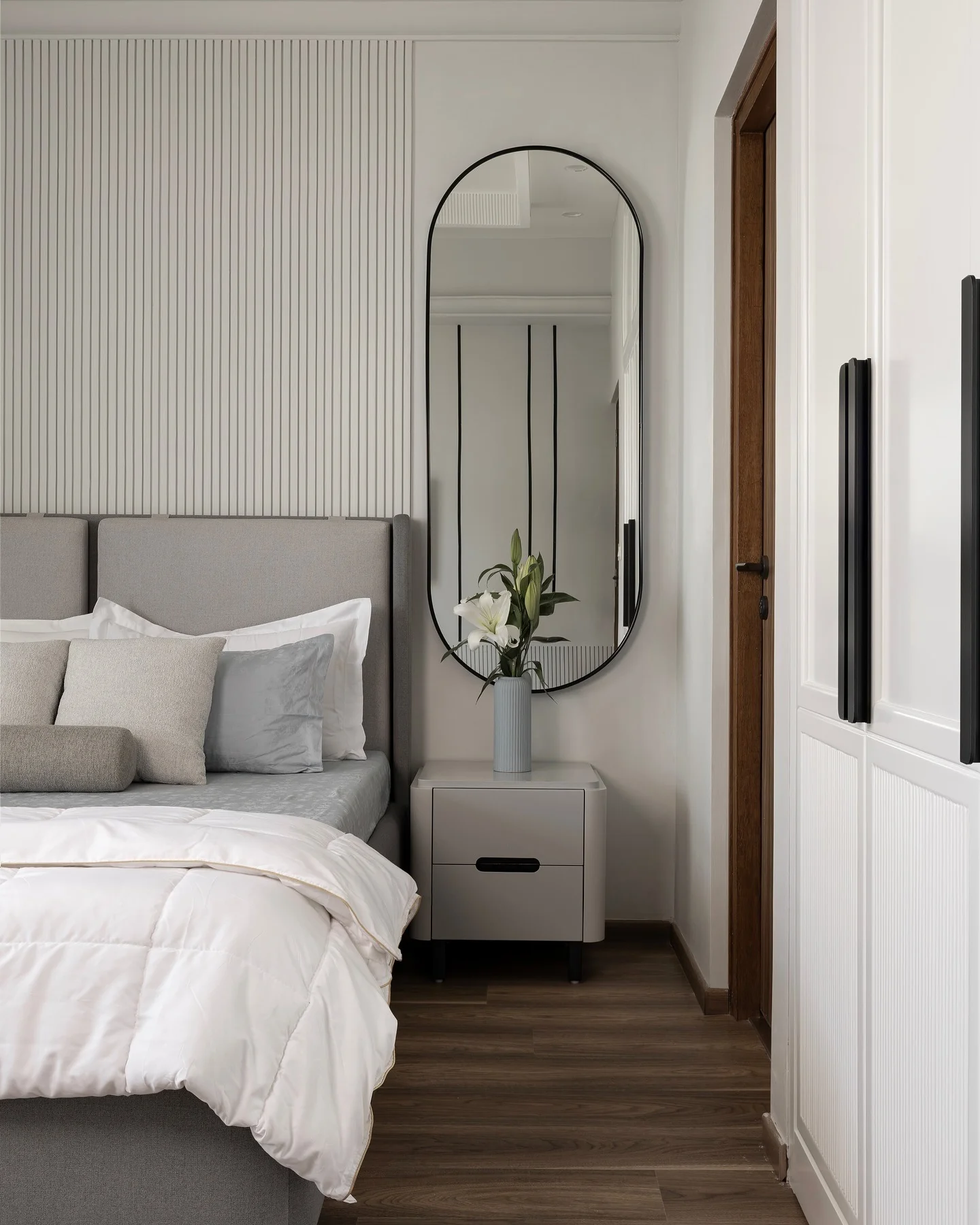 Tall Oval Mirror Reflects Room Details and Adds Height