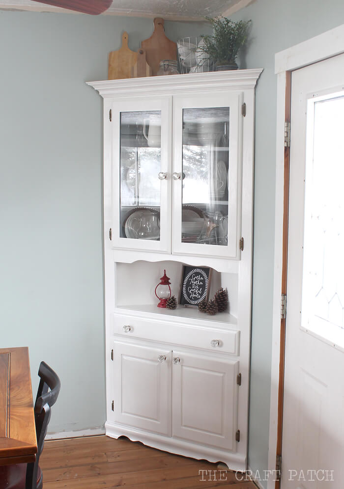 White Corner Cabinet With Glass Doors Displays Kitchenware