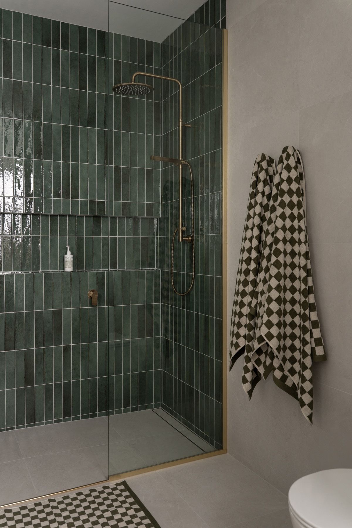Deep Green Vertical Tiles Create a Moody Shower