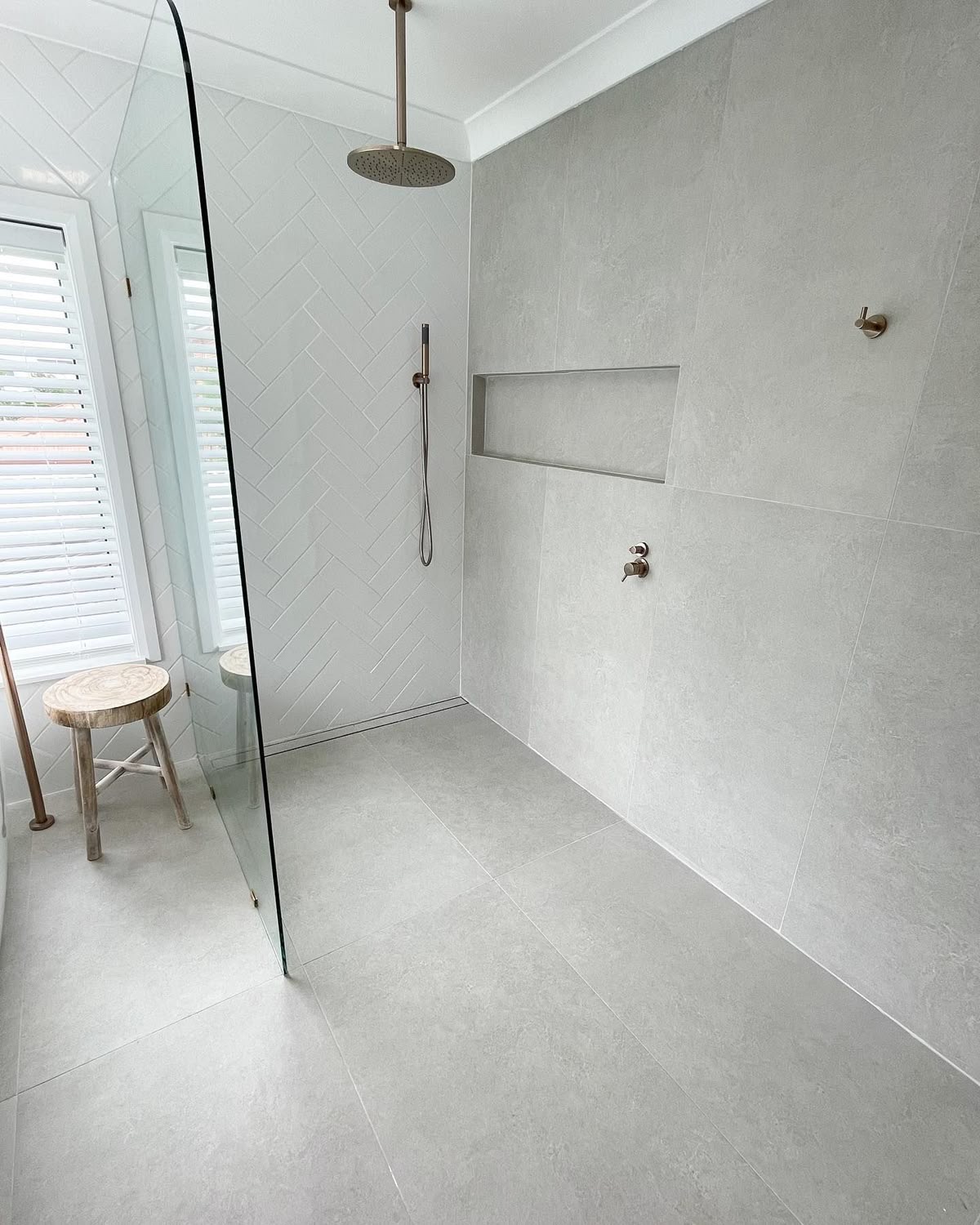 Herringbone White Tile Creates a Textured Shower Accent