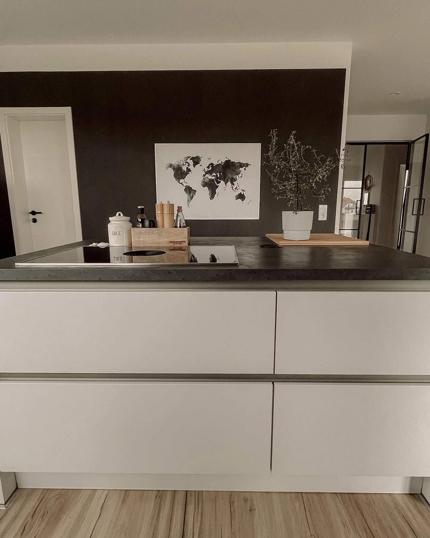 Black Wall Frames a World Map Art Piece